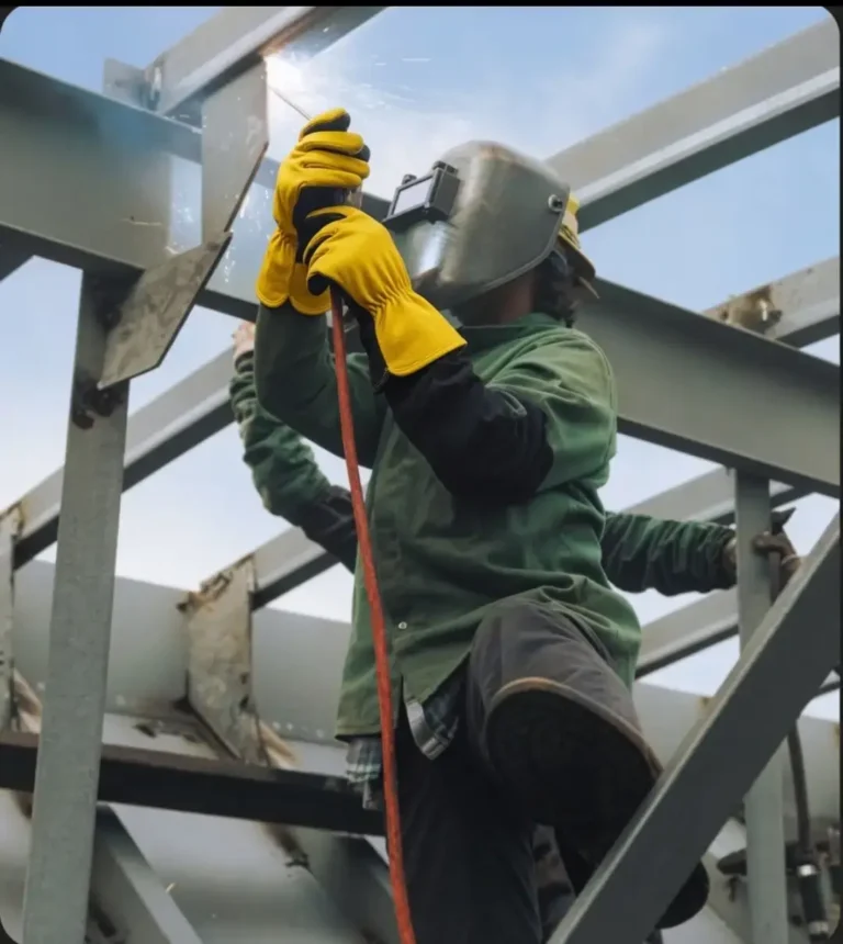 Welder wearing EN 407 certified gloves exposed to sparks and flame