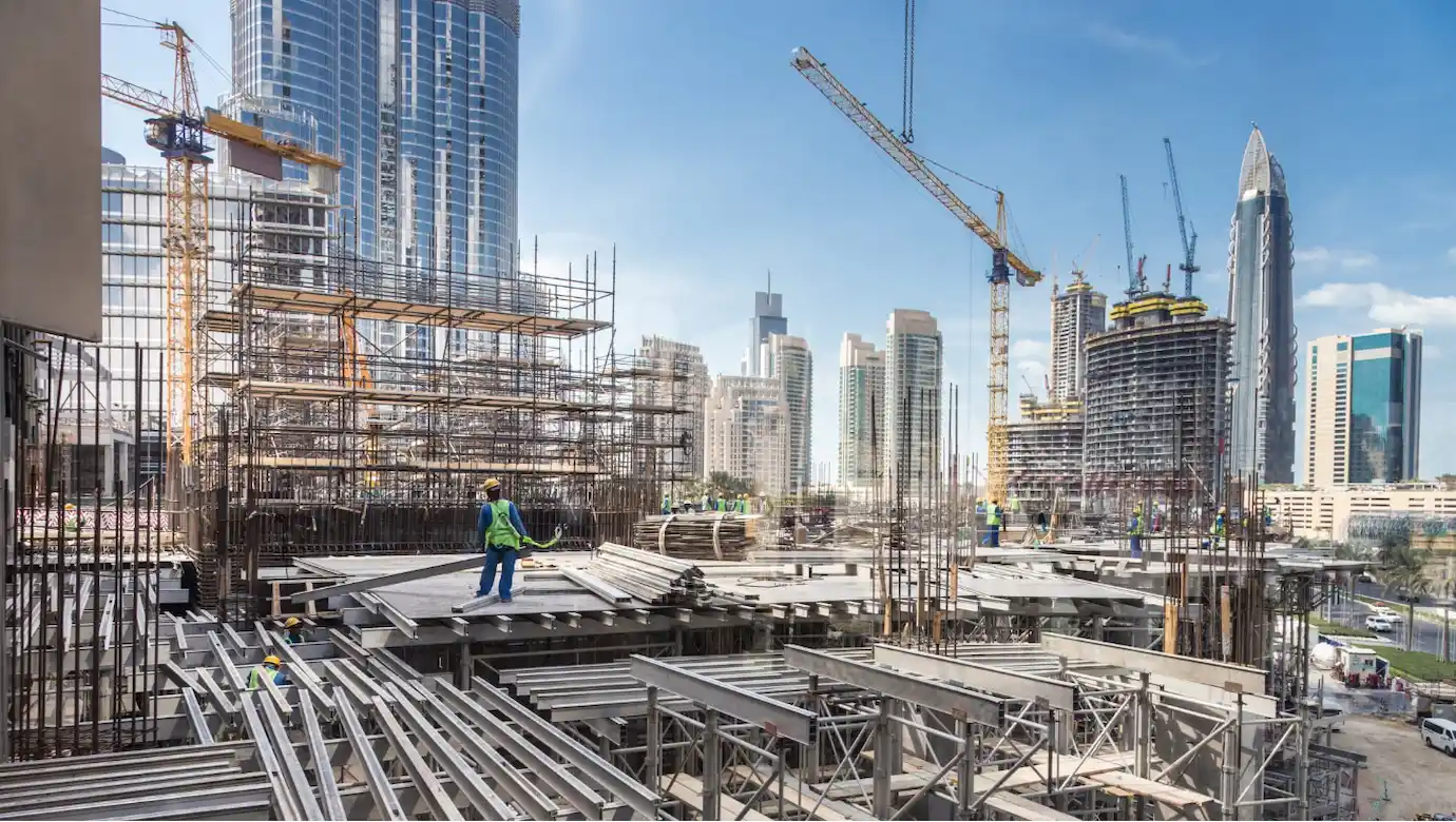 Large-scale industrial construction site utilizing professional welding and safety equipment